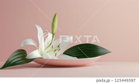 A single white lily with green leaves on a pink plate against a pink background. 125449397
