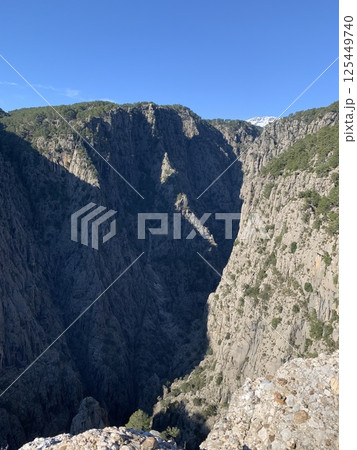 Scenic View of a Vast Rocky Canyon Under Blue Sky 125449740