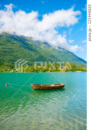 Wooden boat on a mountain lake in a Norwegian fjord. Nature in fjords.  125449820