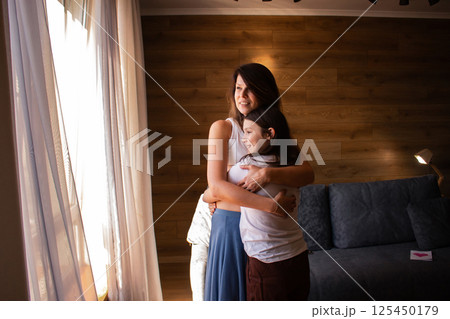 Parent-child therapy concept. Family bonding. mother and daughter practicing secure attachment through loving embrace. Mental Health, psychological topics. Parent-child therapy concept. Family bonding. mother and daughter practicing secure attachment through loving embrace. Mental Health, psychological topics. 125450179