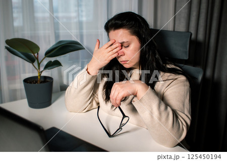 Tired Caucasian woman feeling stressed from work problems. Irritation burnout. Rubbing eyes. Dealing with work deadlines. Have not enough sleep Tired Caucasian woman feeling stressed from work problems. Irritation burnout. Rubbing eyes. Dealing with work deadlines. Have not enough sleep 125450194