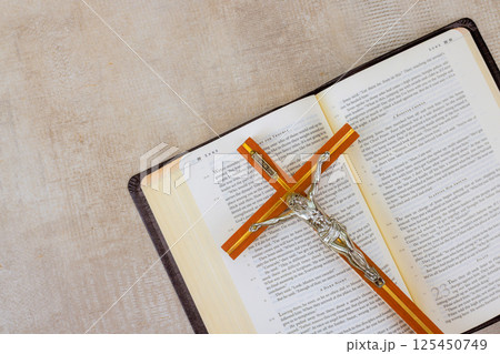 24 April 2025 Washington DC US Crucifix rests on an open Bible, symbolizing faith, spirituality in serene environment. 24 April 2025 Washington DC US Crucifix rests on an open Bible, symbolizing faith, spirituality in serene environment. 125450749