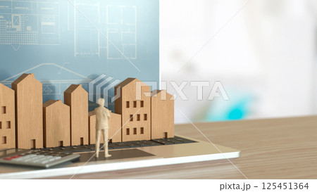 The Man and wood house on Notebook for property or real estate concept 3d Rendering. The Man and wood house on Notebook for property or real estate concept 3d Rendering. 125451364