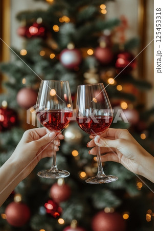 Two people are holding wine glasses and toasting to each other 125453318