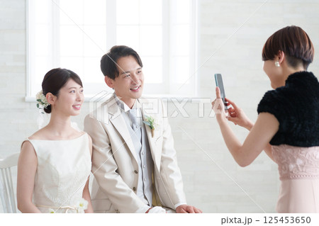 結婚式で新郎新婦を撮影するゲスト 125453650