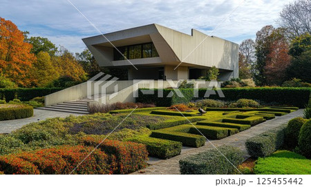 Modern architecture museum in autumn garden with geometric hedges and ramp. 125455442