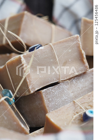 Natural handmade soap displayed in a market during daytime Natural handmade soap displayed in a market during daytime 125456486