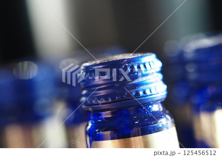 Close-up of blue bottle caps arranged in a vibrant display 125456512