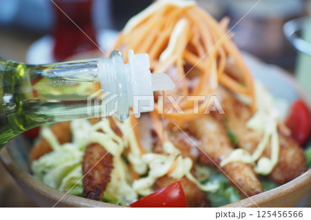 Salad with chicken, fresh veggies, and drizzled oil Salad with chicken, fresh veggies, and drizzled oil 125456566