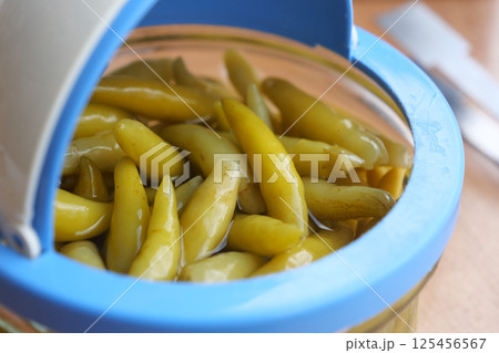 Green peppers preserved in a jar ready for use in cooking 125456567