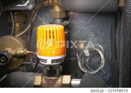 Equipment control valve with orange knob located in mechanical room Equipment control valve with orange knob located in mechanical room 125456619