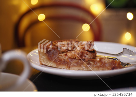 Delicious slice of pie served at a cozy cafe during evening hours Delicious slice of pie served at a cozy cafe during evening hours 125456734
