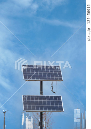 Solar panels capturing sunlight in an urban environment Solar panels capturing sunlight in an urban environment 125456916