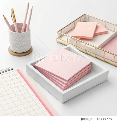 Overlapping pink sticky notes on a clean desk setup 125457751