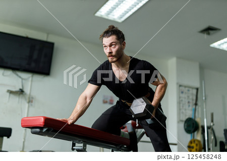 Healthy strong latina male holding dumbbells lifts weights exercise in gym. sport training weights fitness, Exercise to lose weight, take care of health. 125458248