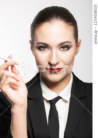 Woman portrait with black suit and cigarette 125458610