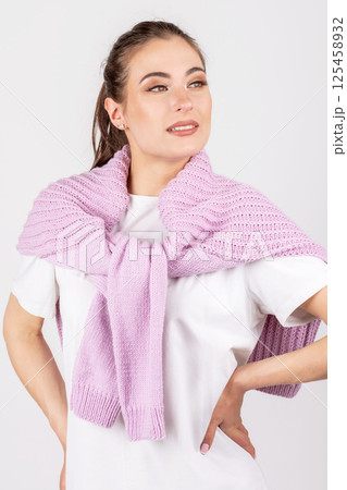 Woman portrait with white shirt and pink sweater on shoulders Woman portrait with white shirt and pink sweater on shoulders 125458932