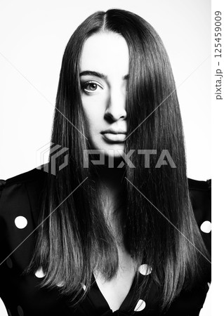 Beautiful woman with long dark hair studio portrait Beautiful woman with long dark hair studio portrait 125459009