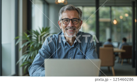 Portrait of mature Indian or Latin hispanic business man ceo manager using laptop computer in modern office. 125460286
