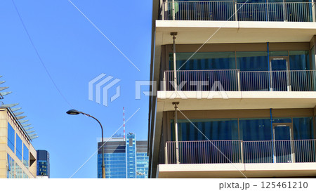 European modern office architecture. View of modern skyscrapers in business district against blue sky. Looking up at business buildings in downtown. European modern office architecture. View of modern skyscrapers in business district against blue sky. Looking up at business buildings in downtown. 125461210