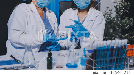 Researcher using a professional microscope Researcher using a professional microscope 125461216