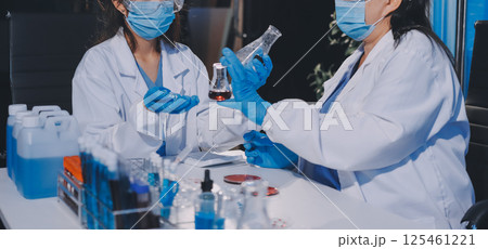 Researcher using a professional microscope Researcher using a professional microscope 125461221