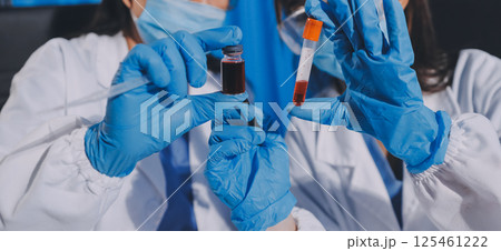 Researcher using a professional microscope Researcher using a professional microscope 125461222