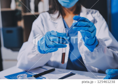 Researcher using a professional microscope Researcher using a professional microscope 125461238