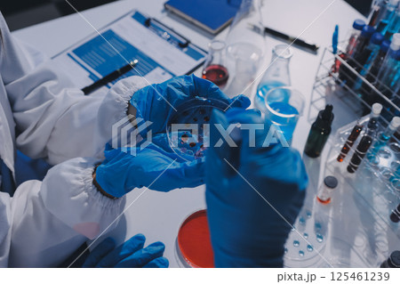 Researcher using a professional microscope Researcher using a professional microscope 125461239