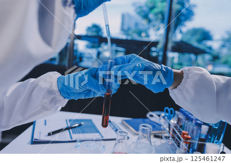 Researcher using a professional microscope 125461247