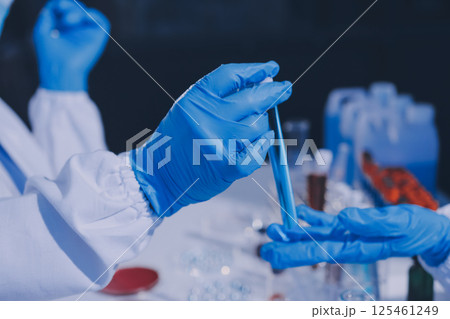 Researcher using a professional microscope Researcher using a professional microscope 125461249