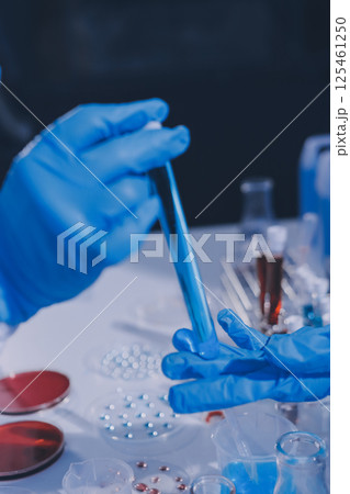 Researcher using a professional microscope Researcher using a professional microscope 125461250