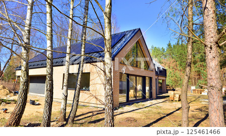 A suburban district of single-family homes. Single family house construction site. Modern designed single-family house under construction. A suburban district of single-family homes. Single family house construction site. Modern designed single-family house under construction. 125461466