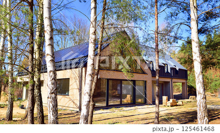 A suburban district of single-family homes. Single family house construction site. Modern designed single-family house under construction. A suburban district of single-family homes. Single family house construction site. Modern designed single-family house under construction. 125461468