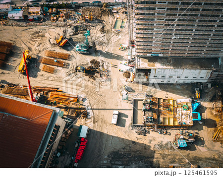 Construction cranes and excavators machinery working in development on construction site. Construction And Development Business. Elevated View construction site area. Development Multistorey Construction cranes and excavators machinery working in development on construction site. Construction And Development Business. Elevated View construction site area. Development Multistorey 125461595