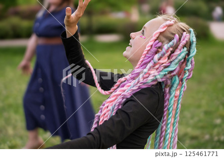 A Joyful Girl with Colorful Hair Enjoying Her Time in the Park with Vibrant Energy and Fun 125461771