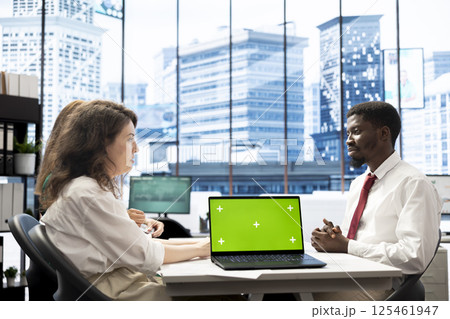 Team of HR experts negotiating job offers and salary packages with candidate, using green screen laptop. Colleagues analyzing applicant resume and cover letter, using mockup notebook 125461947