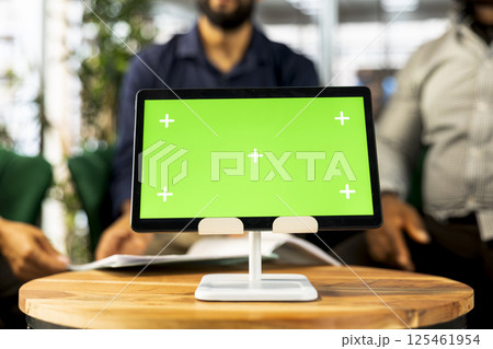 Board of directors in office maintaining strong relationships with business partners, looking at metrics on green screen tablet. Company director shows shareholders data on chroma key device, closeup 125461954