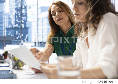 HR experts looking at CVs and doing background checks, discussing about potential job applicants. Human resources specialists reading resumes of candidates for vacant startup business position HR experts looking at CVs and doing background checks, discussing about potential job applicants. Human resources specialists reading resumes of candidates for vacant startup business position 125461991