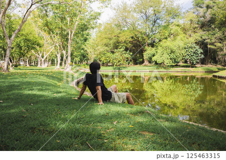 wellness concept with asian man exercise with tree in park on summer season wellness concept with asian man exercise with tree in park on summer season 125463315