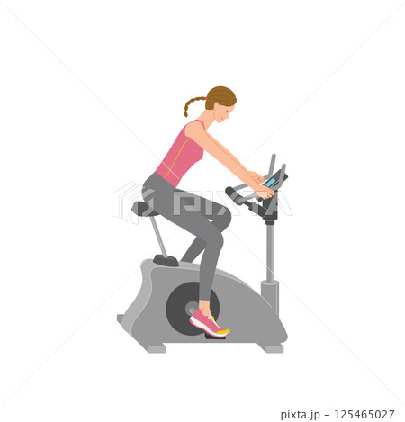 ジムのフィットネスバイクでトレーニングする笑顔の若い女性 125465027