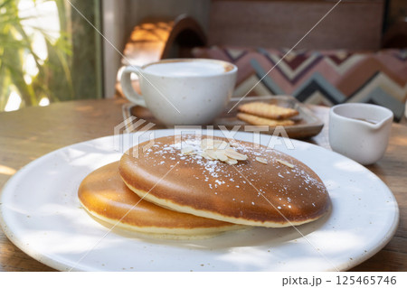 Fluffy Homemade Pancakes with Coffee and Cookies - Cozy Sunlit Breakfast on Wooden Table. Minimalist Brunch Aesthetic 125465746