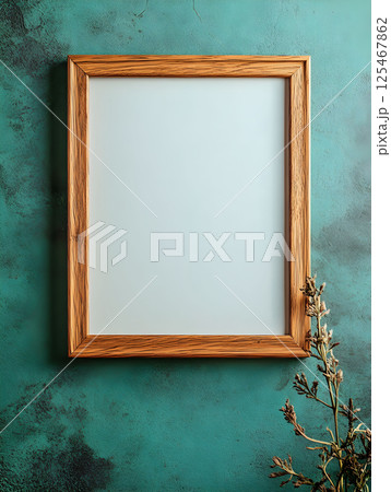 Framed blank vertical frame for mockup against textured teal wall with dried flowers for creative decoration ideas in interior design 125467862