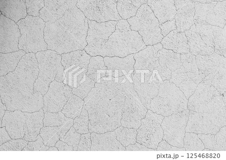Abstract pattern of cracks on a white concrete wall surface, background Abstract pattern of cracks on a white concrete wall surface, background 125468820