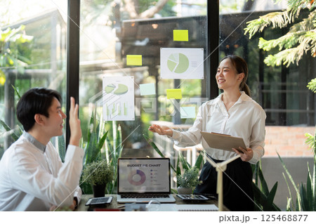 Effective Team Meeting on Sustainable Initiatives. Presenters share insights and discuss eco-friendly strategies with visuals. Effective Team Meeting on Sustainable Initiatives. Presenters share insights and discuss eco-friendly strategies with visuals. 125468877