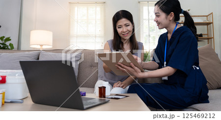 Elderly client receiving personalized care advice from caregiver during a consultation at home Elderly client receiving personalized care advice from caregiver during a consultation at home 125469212