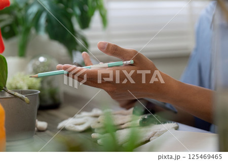 Gardening and Sustainability. A person engages in eco-friendly gardening practices while preparing to care for plants. Gardening and Sustainability. A person engages in eco-friendly gardening practices while preparing to care for plants. 125469465