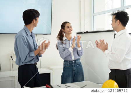 Positive Work Environment and Team Recognition. Architects and engineers applaud each other's contributions. Positive Work Environment and Team Recognition. Architects and engineers applaud each other's contributions. 125469755