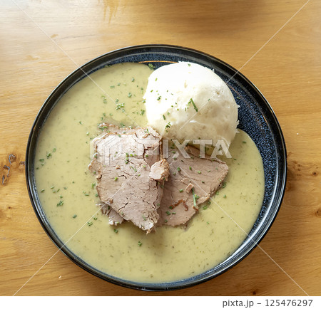 Mashed potatoes with dietary turkey meat in creamy sauce on a plate. Top view 125476297