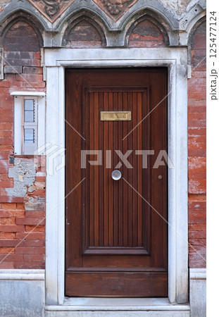 Door on brickwall facade 125477124